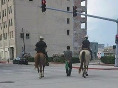 Viral Photo Shows TX Police Officers On Horseback Leading Handcuffed Man By Rope