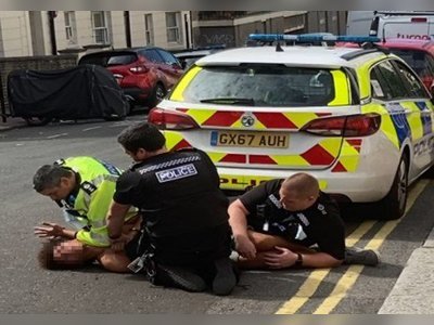 Man shouts 'I can't breathe' as he's pinned down by three police officers