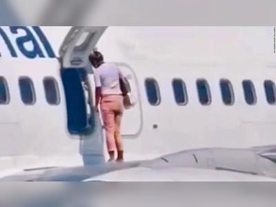The shocking moment a passenger took a walk on an airplane wing