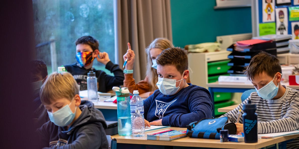 An unvaccinated teacher spread COVID-19 to 50% of students in a classroom after taking off a mask to read, CDC says