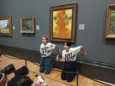 Just Stop Oil activists throw soup at Van Gogh’s Sunflowers, then glue themselves to wall beneath painting at National Gallery in London